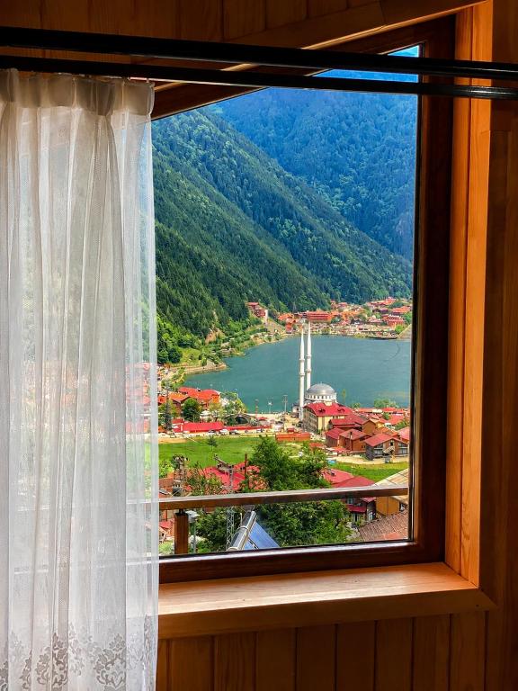 a window with a view of a town and a lake at Auga Apart in Uzungöl