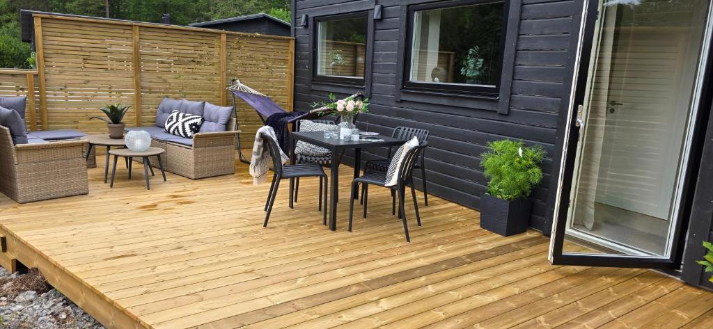 a patio with a table and chairs on a deck at Lösen Retreat in Lyckeby