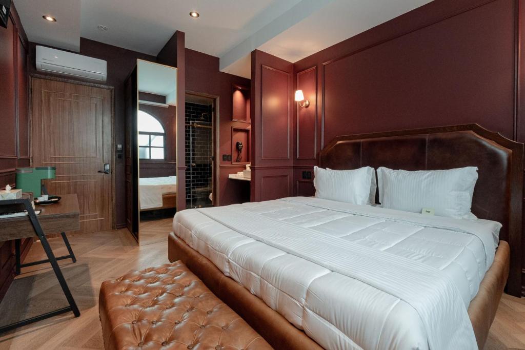 a bedroom with a large bed and a bathroom at The Ruby Suite luxury room in Mexico City
