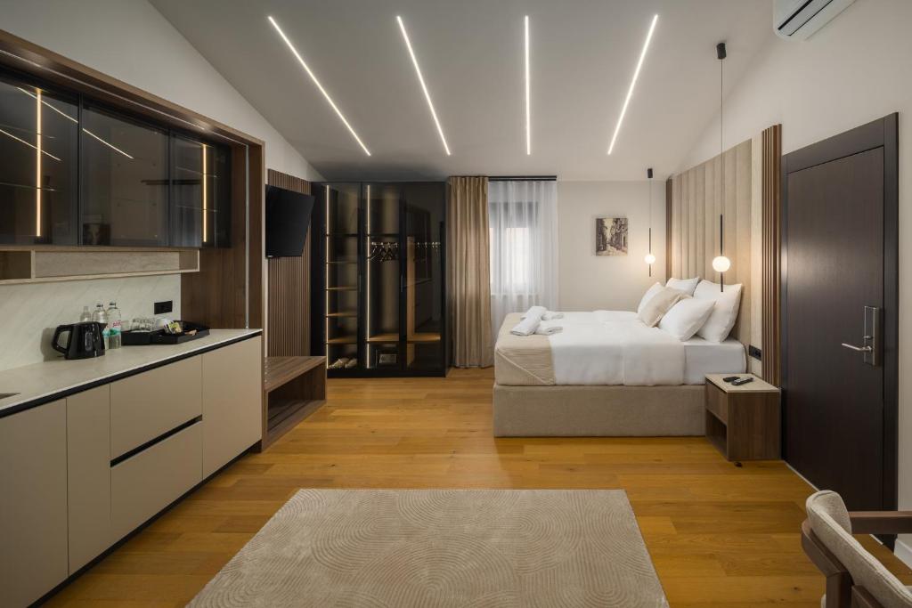 a hotel room with a bed and a kitchen at Heritage Hotel Ames in Poreč