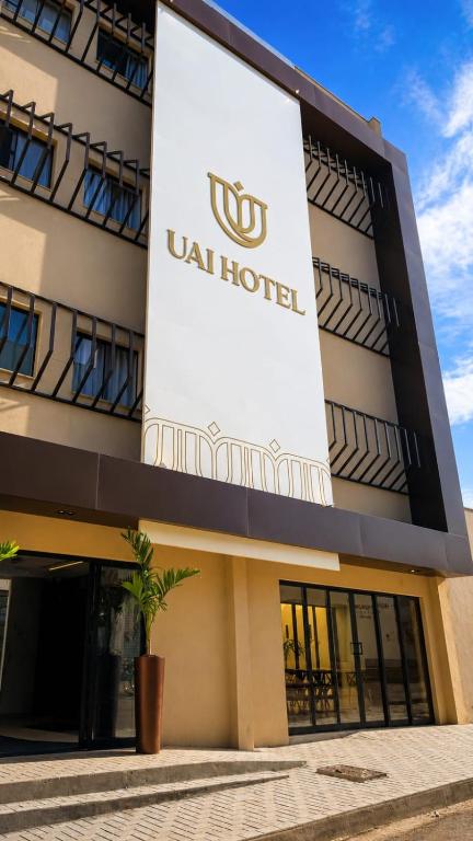 a building with a sign on the side of it at Uai Hotel Jaíba in Terra Fôfa