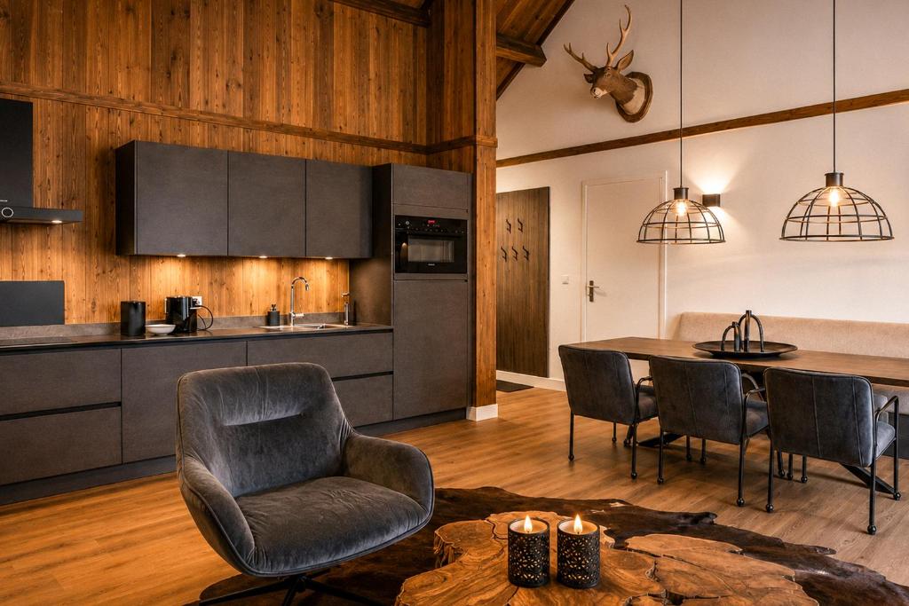a kitchen and dining room with a table and chairs at Stylish Loft Apartment with Mountain View near the Lake in Afritz