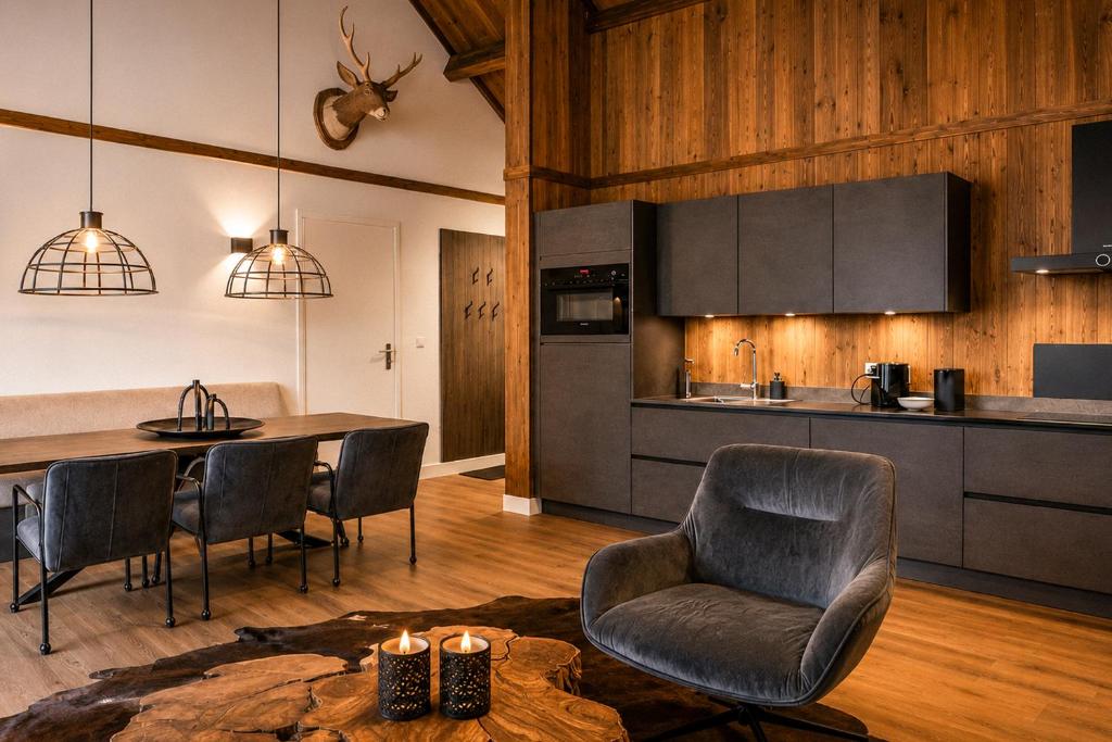 a kitchen and dining room with a table and chairs at Stylish Loft Apartment with Mountain View near the Lake in Afritz