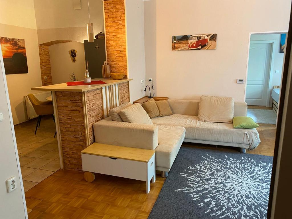 a living room with a couch and a kitchen at Old town Wall Radovljica - Appartment in Radovljica