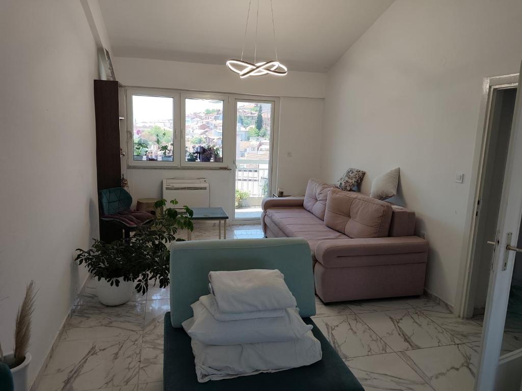 a living room with a couch and a table at Golden Age Rooftop Apartment in Ohrid