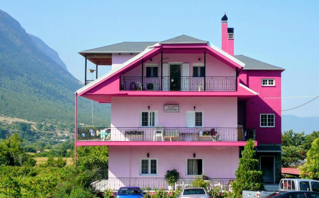 a pink building with a lighthouse on top of it at Γαλήνη in Konitsa