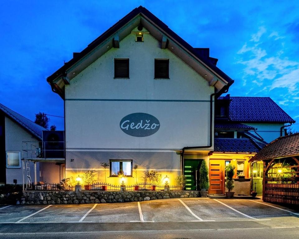 a building with a sign on the side of it at Gostilna in prenočišča Gedžo in Novo Mesto
