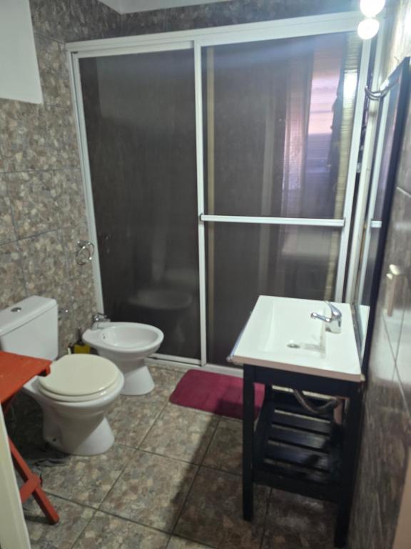 a bathroom with a shower and a toilet and a sink at Calma chicha casa 1 in Cortaderas
