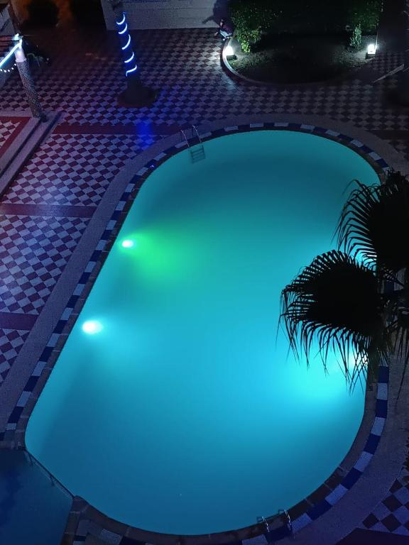 a swimming pool with blue lights in a resort at Arenabeach in Martil