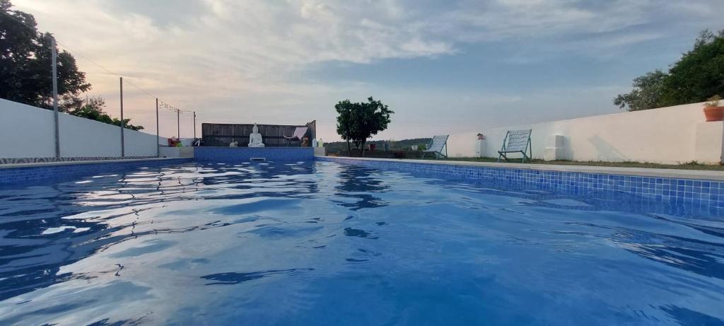 a large swimming pool with blue water at Casa Alentejana in Mora