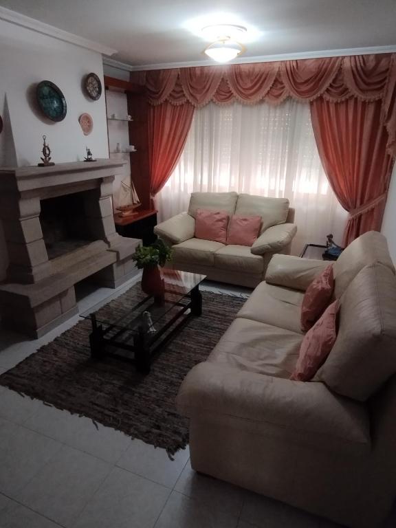 a living room with a couch and a fireplace at Piso de Verano in O Grove
