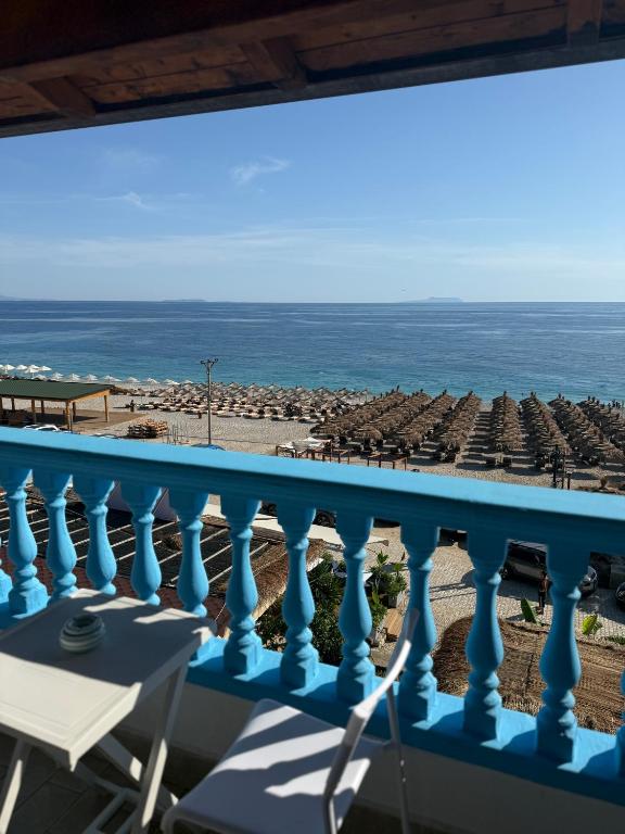a balcony with a view of the beach and the ocean at Yamas Hotel "Ex Malibu" in Dhërmi