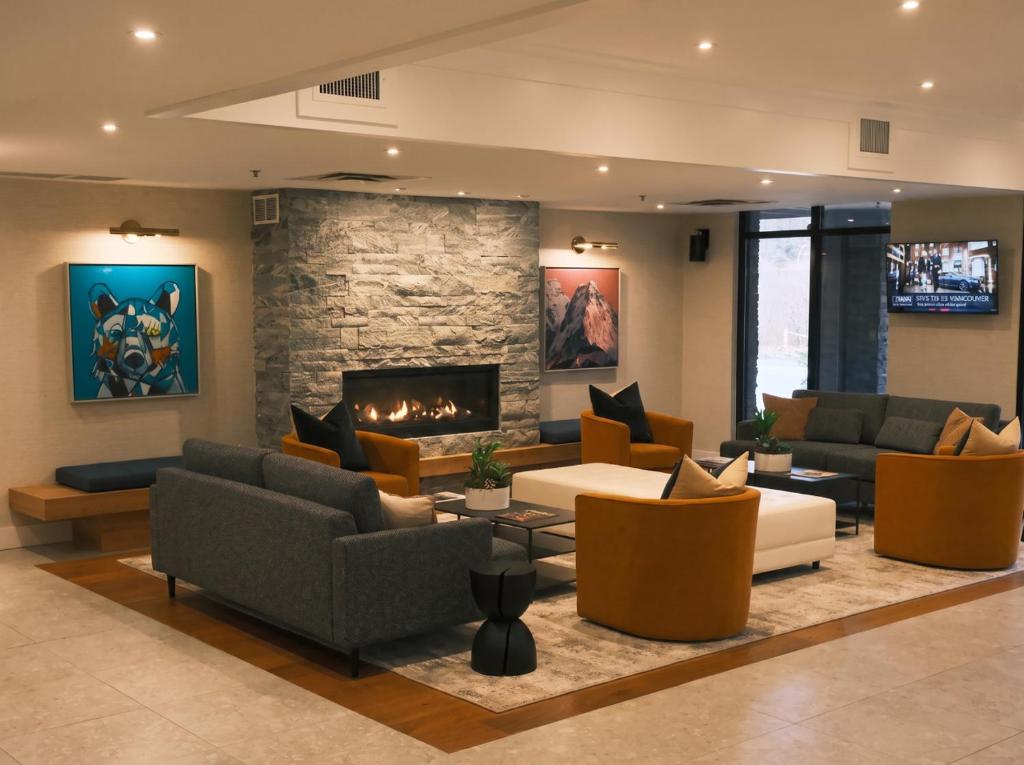 a living room with couches and a fireplace at Executive Suites Hotel and Resort, Squamish in Squamish