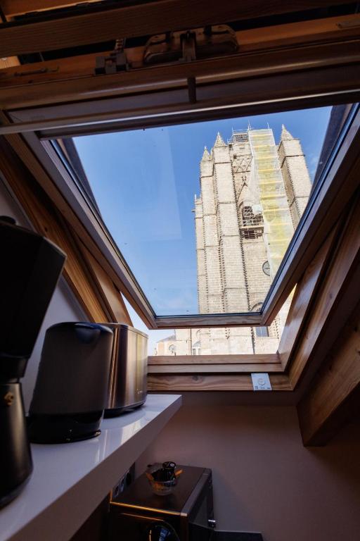 a view of a building through a window at apartamentos catedral suite in Ávila