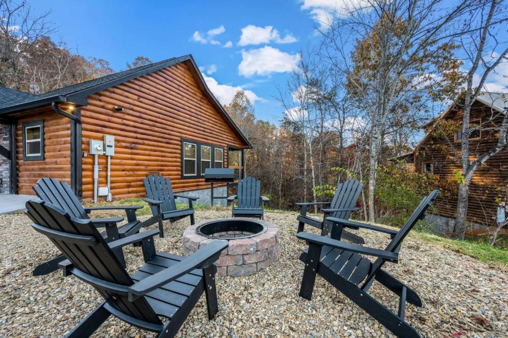 a group of chairs sitting around a fire pit in front of a cabin at Top Rated Modern 3BD |Secluded |Fire Pit |Arcade in Sevierville