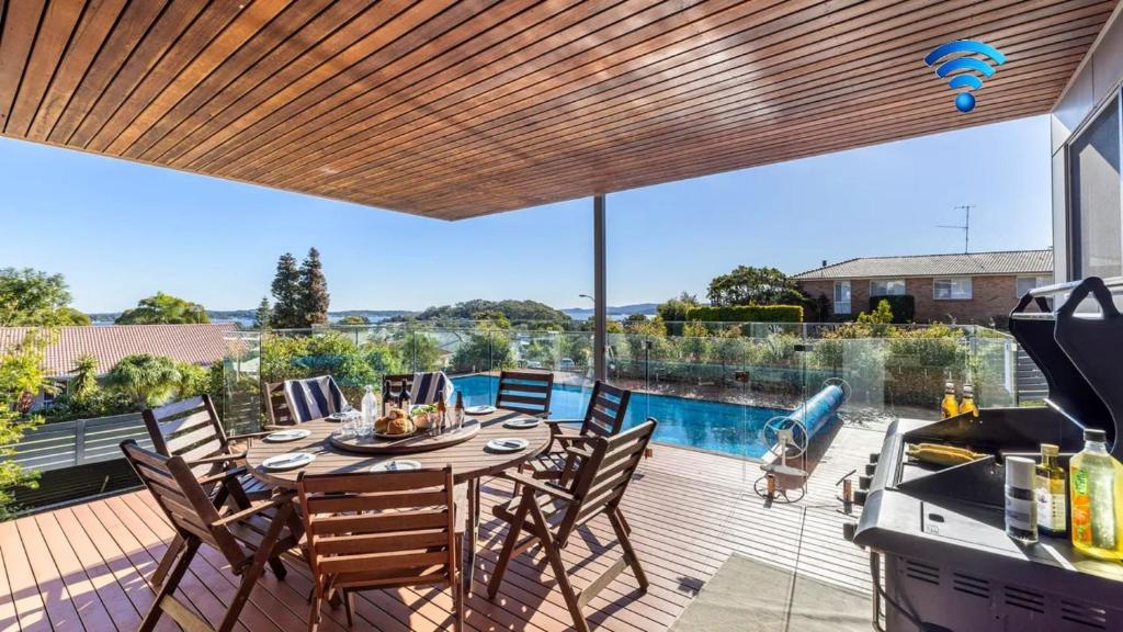 a patio with a table and chairs on a deck at The Family Tide in Corlette