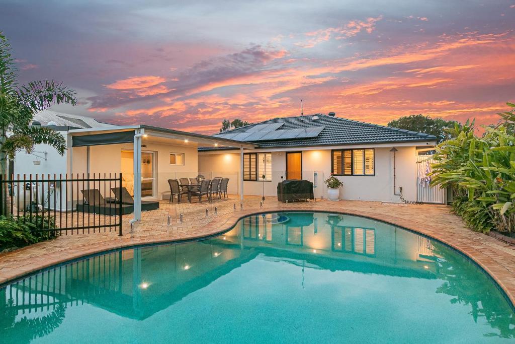 a swimming pool in front of a house at Salthill in Tweed Heads