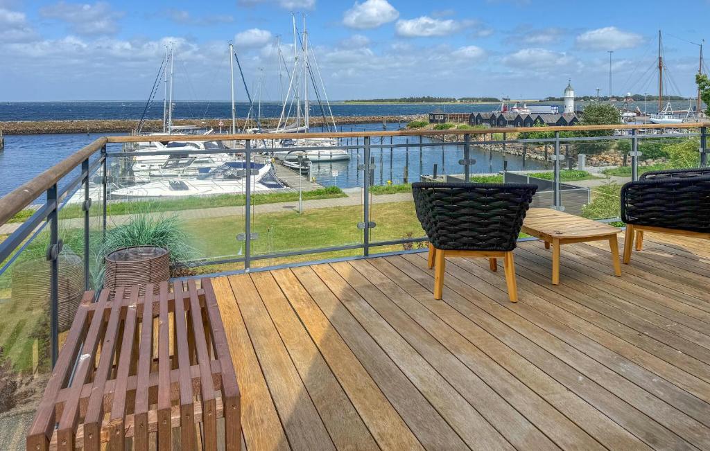 a deck with two benches and a view of a marina at Awesome Home In Haderslev With Sauna in Haderslev