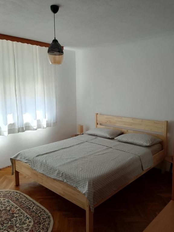 a bedroom with a bed in a white room at Casa SOLE in Bihać