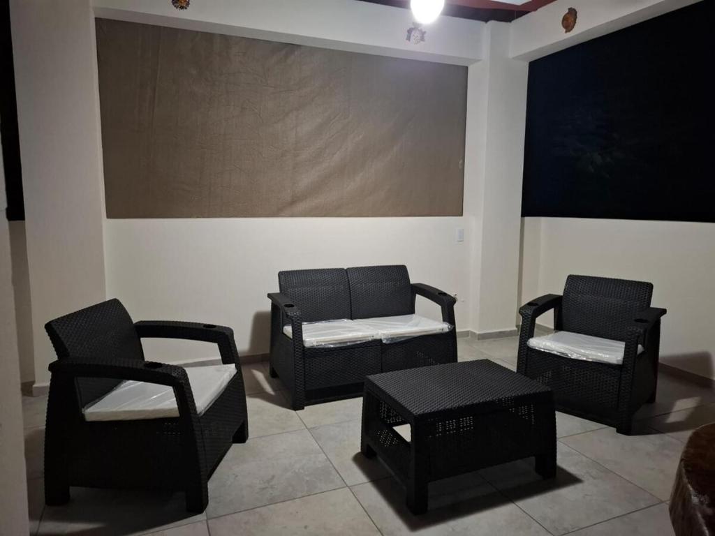 a room with three chairs and a table at Huatulco house near beach with pool in Tangolunda