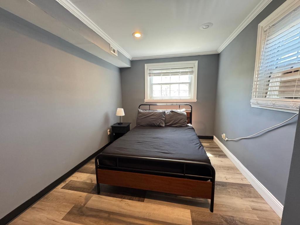 a bedroom with a bed and a window at Cozy Modern 2-Bedrooms Apartment DC in Washington, D.C.