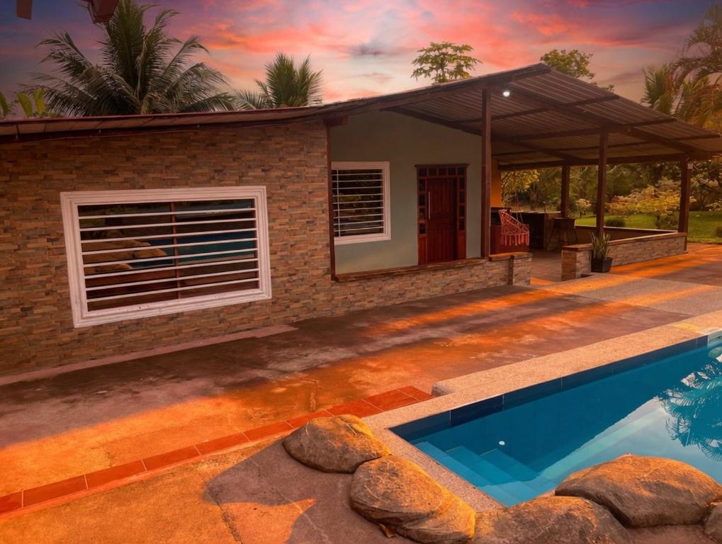 a house with a swimming pool in front of it at Guanawanna in Loreto