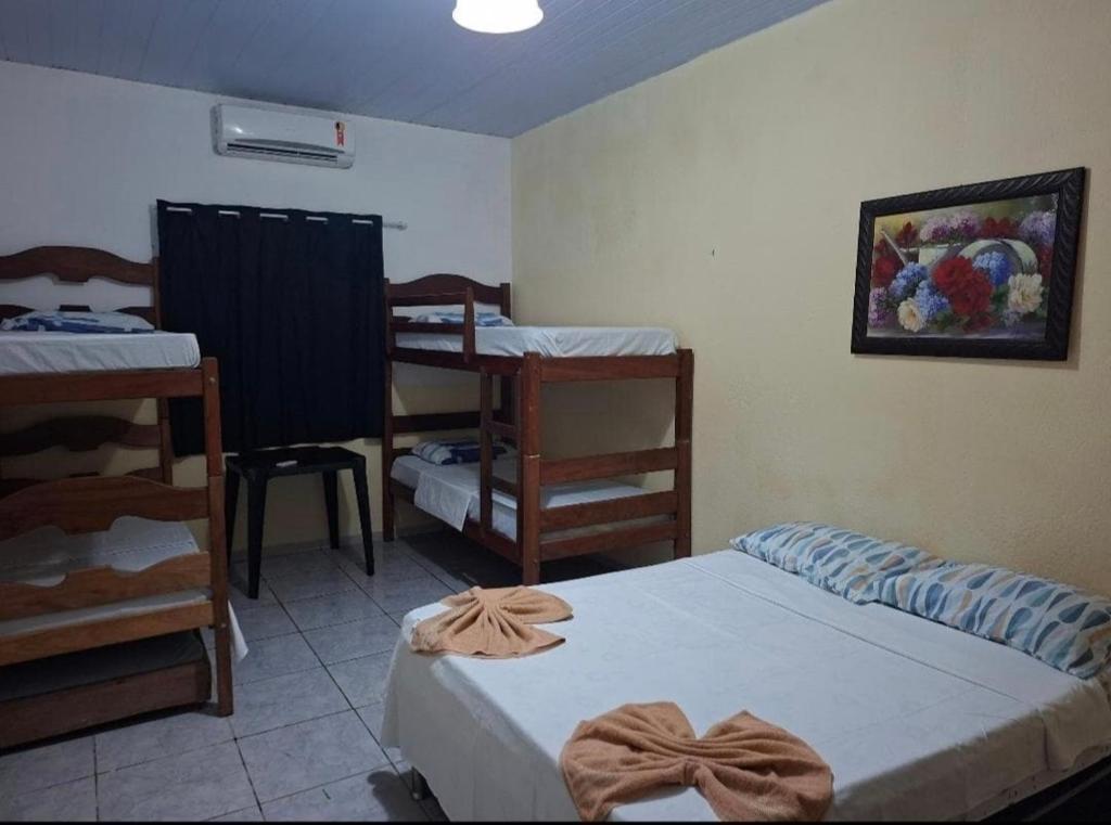 a bedroom with two beds and a table and chairs at Anthony in Salinópolis