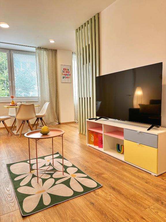 a living room with a large flat screen tv at Sitka1 apartment in Trenčín