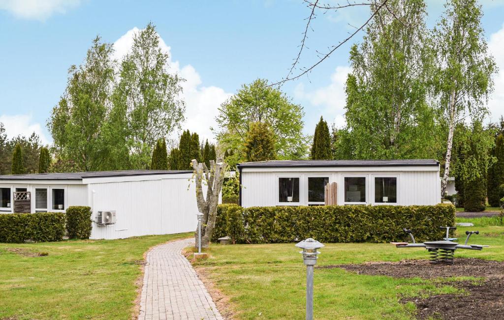 a white house with a garden in front of it at Beautiful Home In Ystad in Ystad