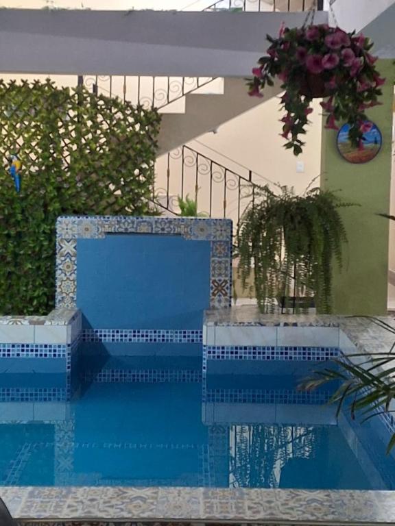 a blue bench sitting next to a swimming pool at Balneario del Inca in Los Baños del Inca