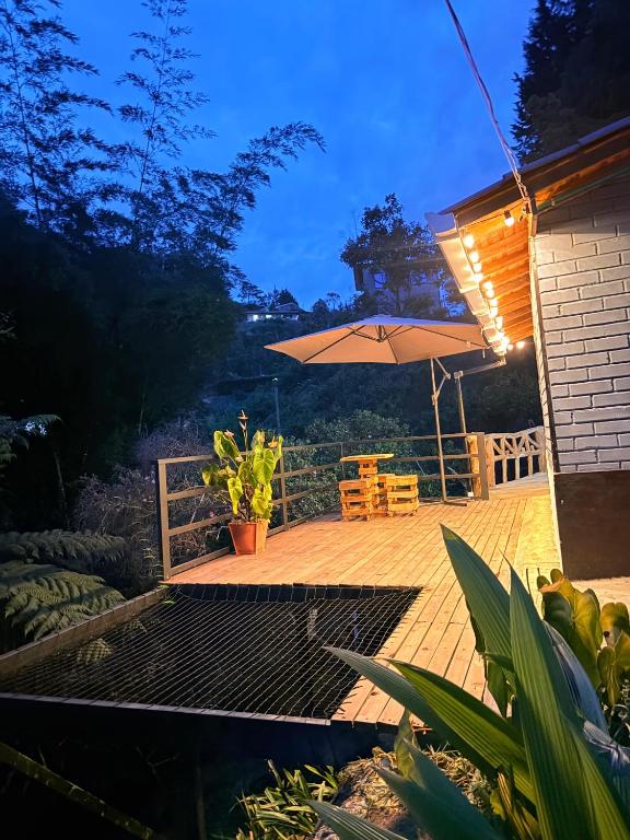 a patio with an umbrella and a table and chairs at Cabaña Alto Verde in Chiquinquirá
