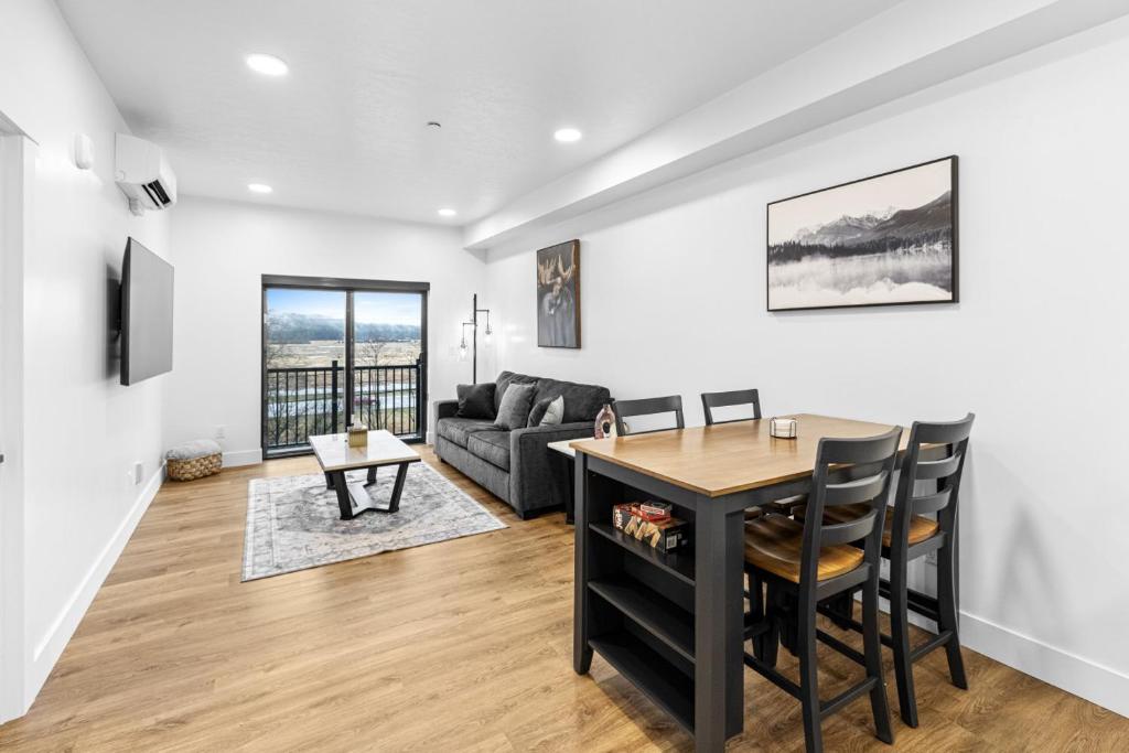 a living room with a table and a couch at Airport Access with Stunning View A103 in Juneau