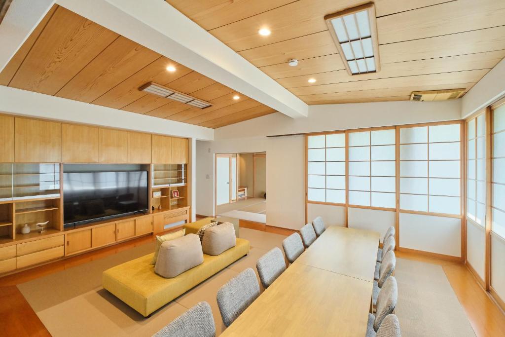 a living room with a couch and a flat screen tv at Yunokawa Kagura in Hakodate