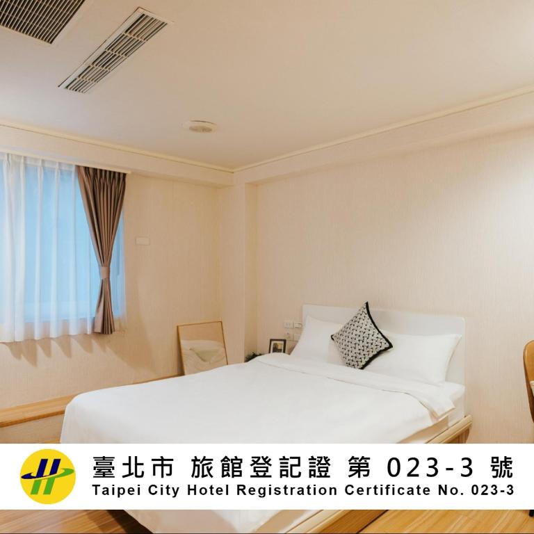 a hotel room with a bed and a window at Meworld Hotel - Zhongshan in Taipei