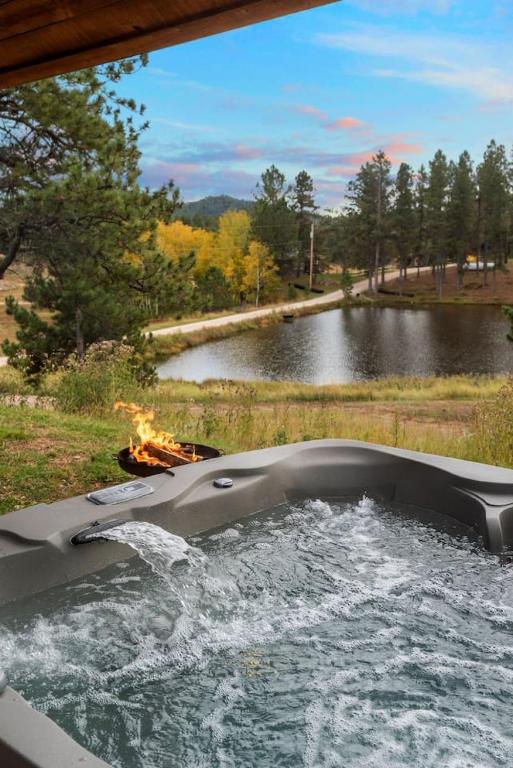 a boat with a fire in the middle of a lake at Sun Filled Joy BHBungalows #8 in Custer