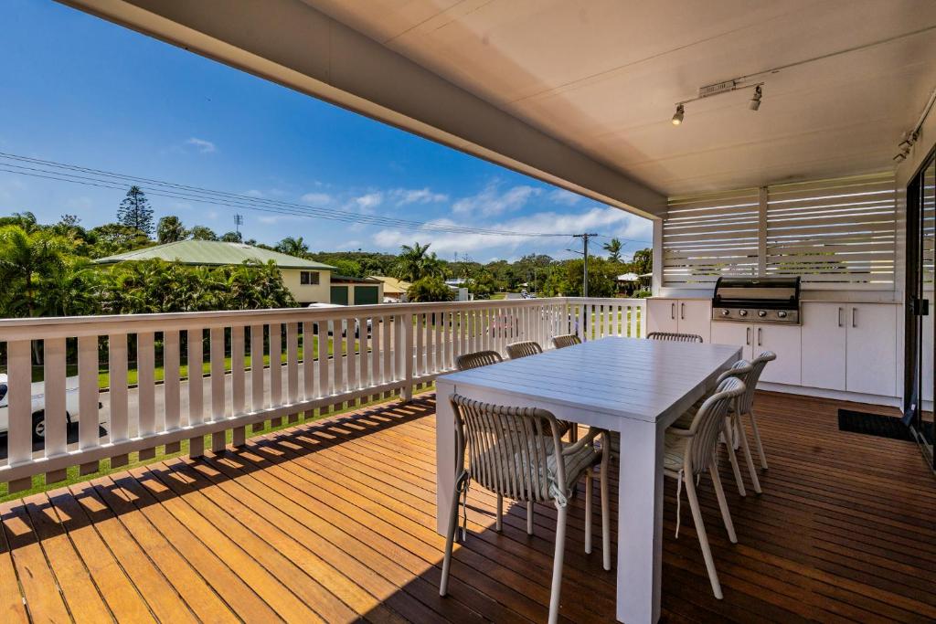 a porch with a white table and chairs on a deck at A Lure - 100m to Main Beach in Agnes Water