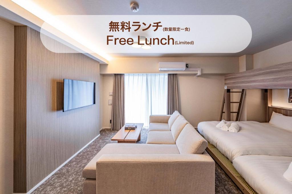 a hotel room with two beds and a television at Apartment Hotel 11 Shinsekai in Osaka