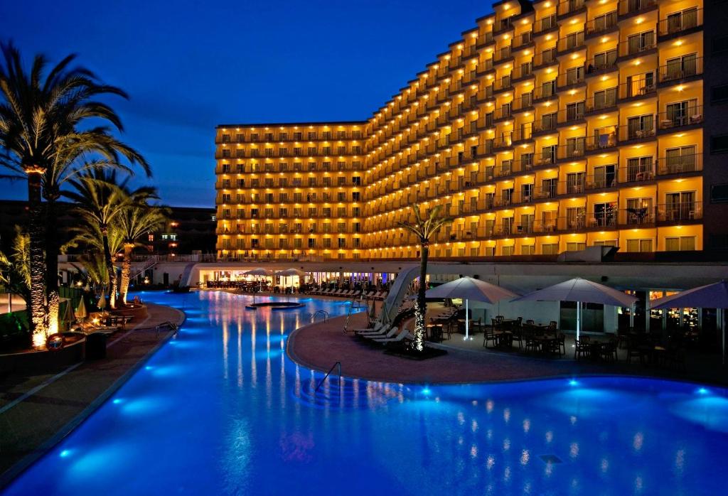 a hotel with a swimming pool in front of a building at SOL by Meliá Guadalupe in Magaluf