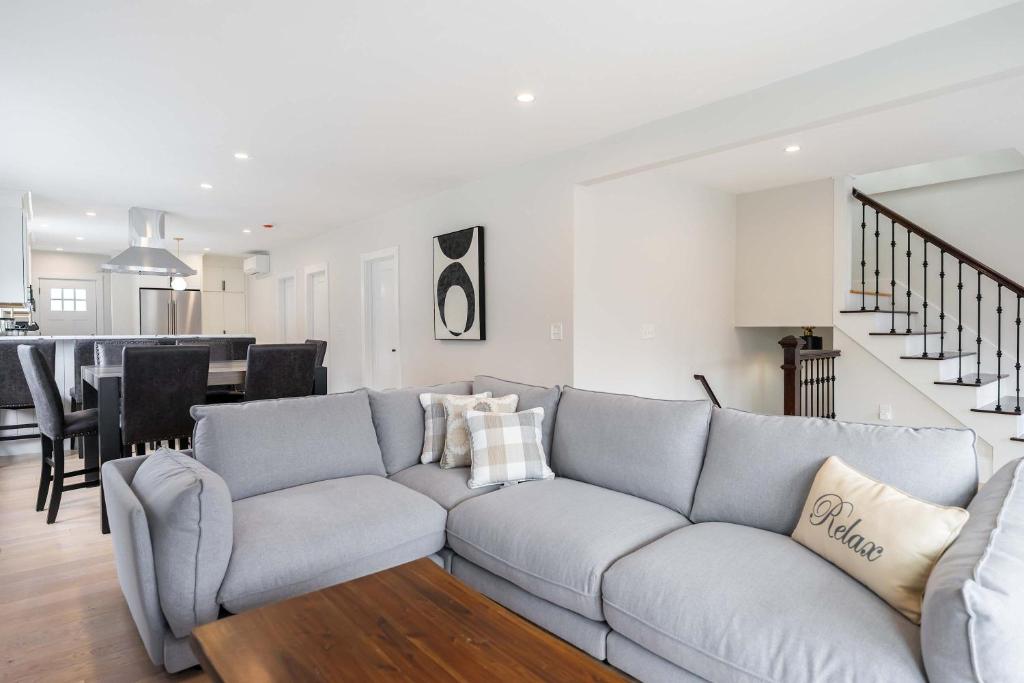 a living room with a couch and a dining room at Beautiful and Spacious 3BD Condo in Somerville in Somerville