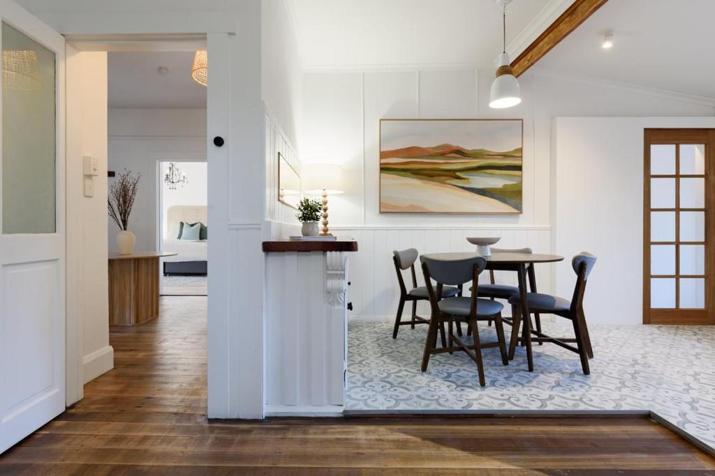 a dining room and kitchen with a table and chairs at Garden Cottage, Wellness Studio & Bike Shed in Winnaleah