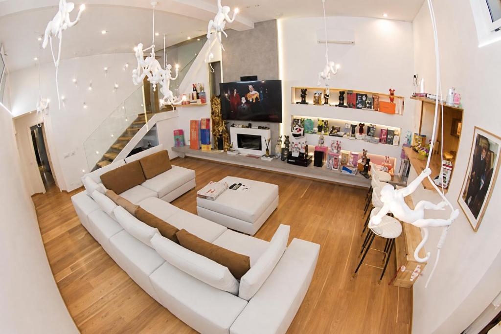 a living room with a couch and a table at Milan Luxury Loft with Sauna & Jacuzzi in Milan
