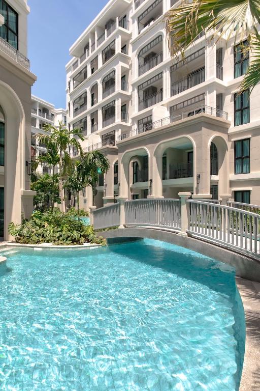 a swimming pool in front of a building at Title Legendary Studio with Balcony by TVC C407 in Bang Tao Beach