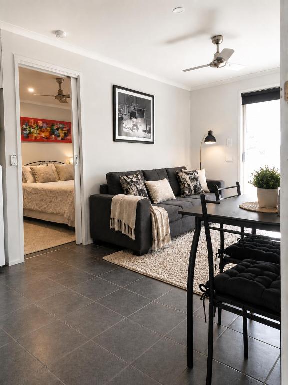 a living room with a couch and a table at Golfside Getaway by Ready Set Stay in Rosebud