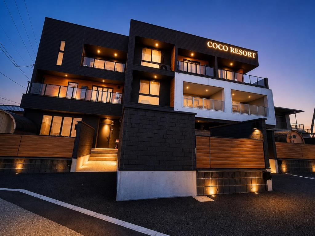 a black building with a coco nesting sign on it at Coco Resort Futtsu in Futtsu