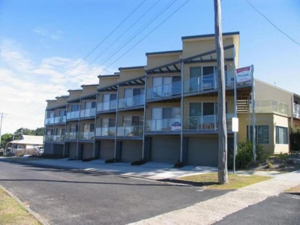 a building with balconies on the side of a street at Seaspray 8 - Ocean Views - Stone Real Estate Yamba in Yamba