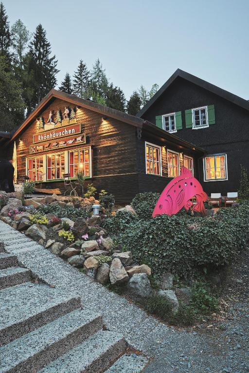 a house with a garden in front of it at Hotel & Restaurant Rhönhäuschen in Bischofsheim an der Rhön