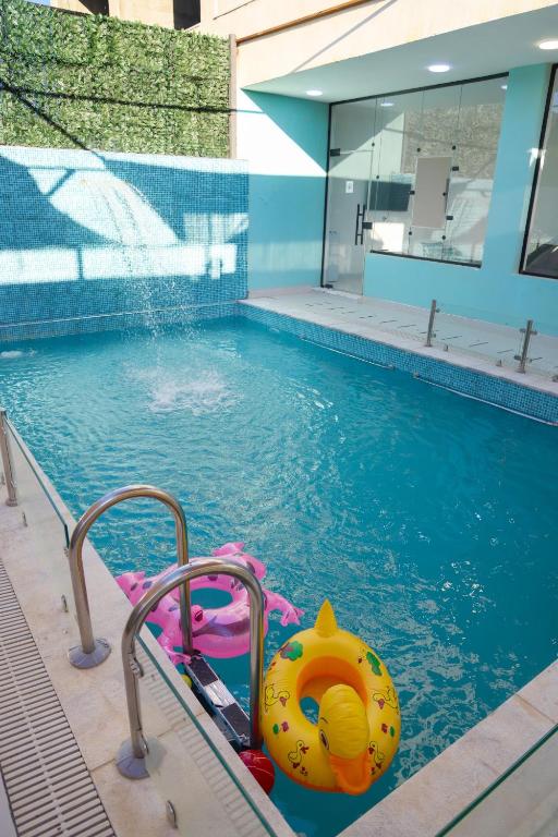 a swimming pool with a toy in the water at Airport Chalet مزرعة وشاليه المطار in Amman
