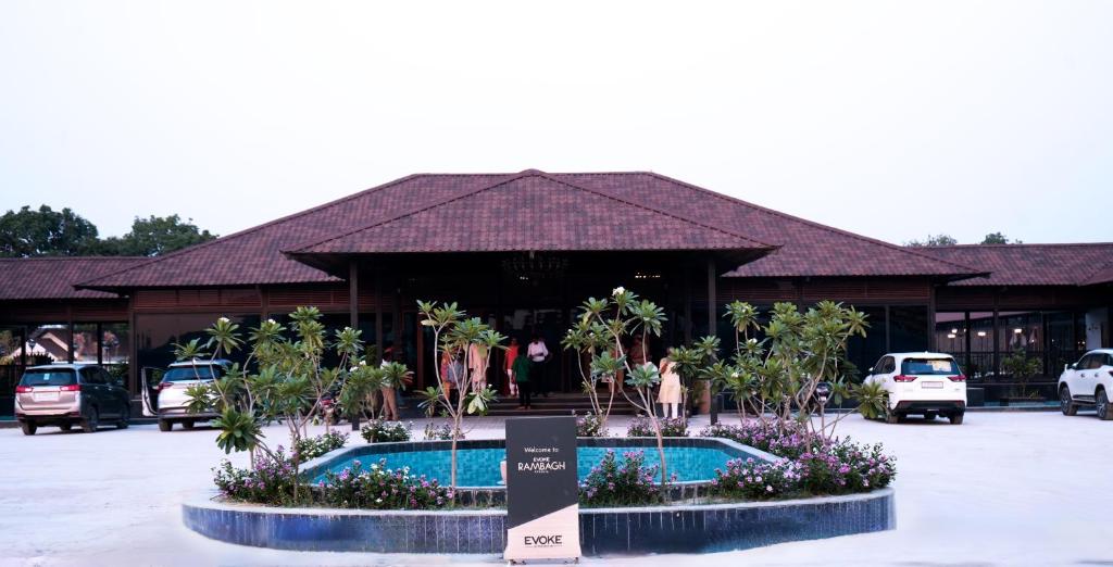 a resort with a building with a pool in front of it at Evoke Rambagh Resort Ayodhya in Ayodhya