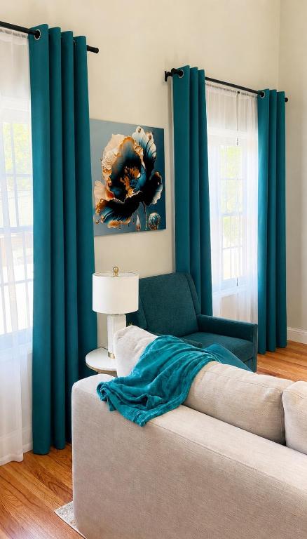 a living room with blue curtains and a couch at Private 1BR Apt, WiFi, Reliable, Near NYC in Scotch Plains
