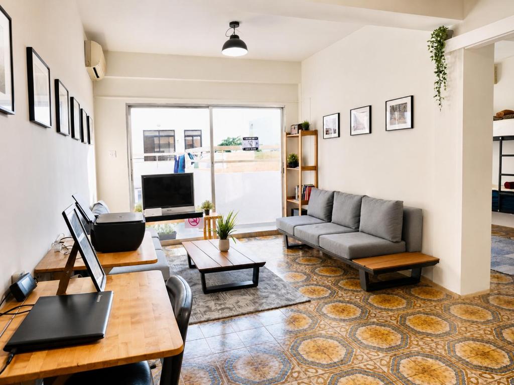 a living room with a couch and a table at Swift Hostel Limassol in Limassol